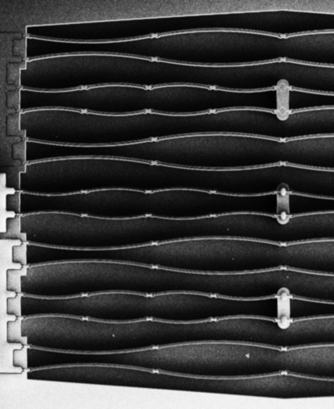 Ausschnitt geöffneter Chip eines MEMS Mikrolautsprecher Bauelementes mit parallel angeordneten Aktor-Paaren Ausschnitt geöffneter Chip eines MEMS Mikrolautsprecher Bauelementes mit parallel angeordneten Aktor-Paaren